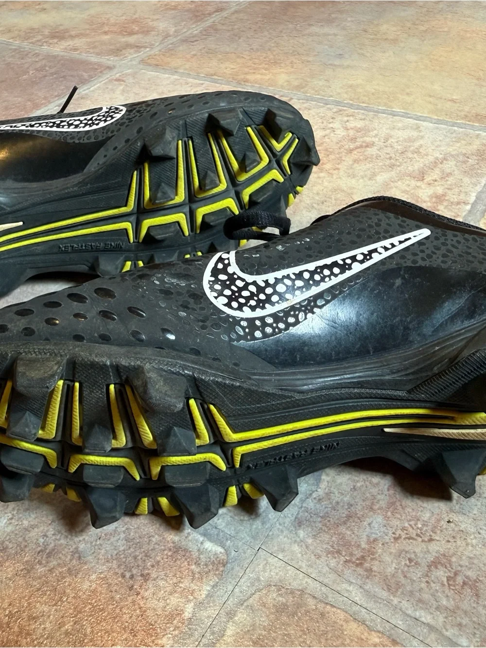 Nike Black Cleats with White Swoosh Accent
